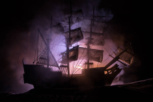 istock Black silhouette of the pirate ship in night 1263381108