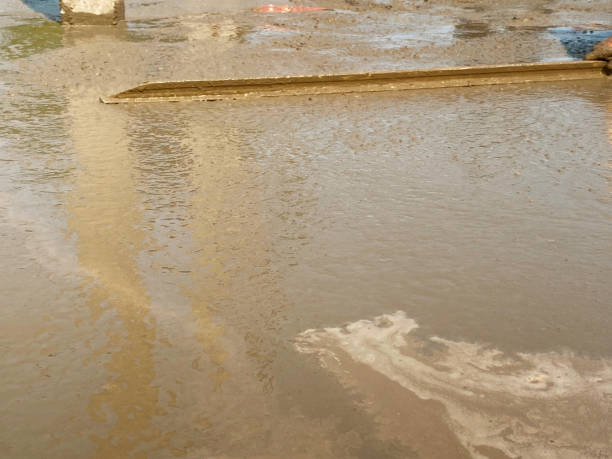 istock Worker plaster rough and wet cement on floor by screed 1263388166