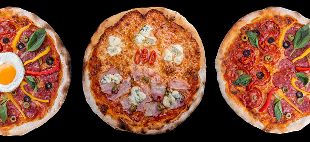 Three different pizzas in one set, isolated on black, top view