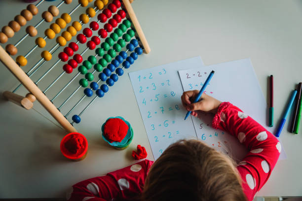 istock little girl learning numbers and counting, kid doing homework 1263398901