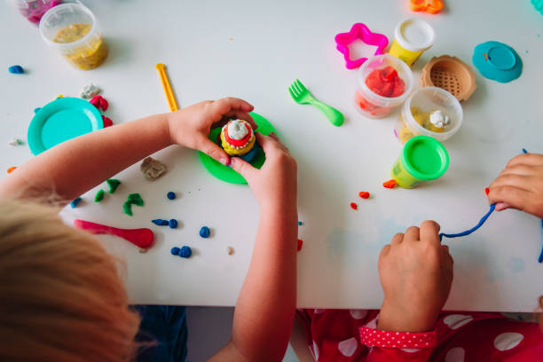istock kids play with clay molding shapes, learning through play 1263399293