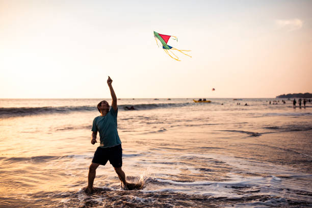 A girl flies a kite near sunset on the beach in Newport, Oregon.