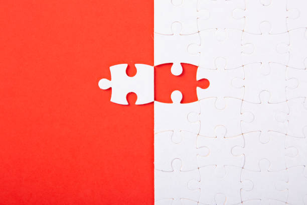 istock Blank white puzzle pieces on red background, flat lay. Space for text 1263405603