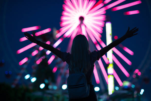 istock Lovely young woman having fun at a amusement park 1263405665