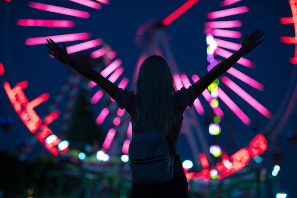 istock Lovely young woman having fun at a amusement park 1263407561