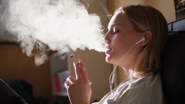 Young Woman Smoking Cannabis