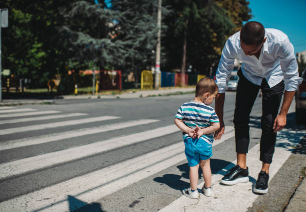 istock Father and son walking on street 1263410914