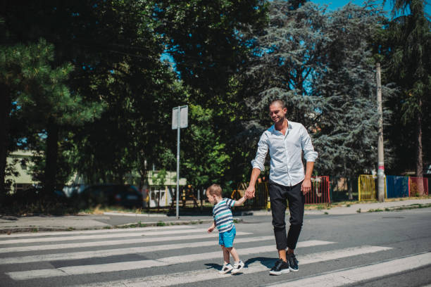 istock Father and son walking on street 1263412534