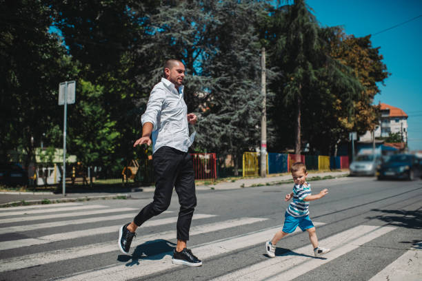 istock Father and son walking on street 1263412798