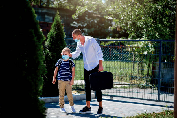 istock Single father going to work and taking son to school during epidemic. 1263413766