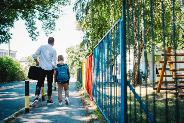 istock Single father going to work and taking son to school during epidemy 1263414292