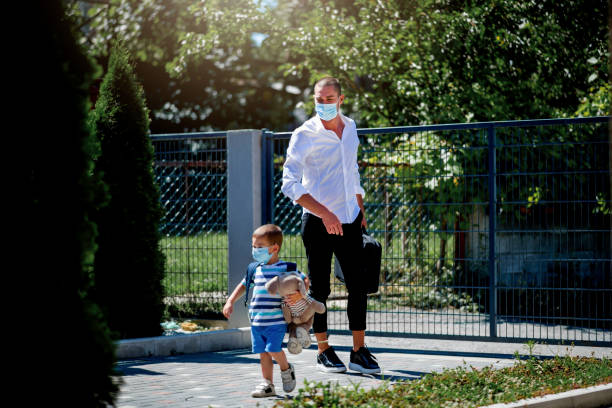 istock Young businessman taking son to preschool. 1263415968