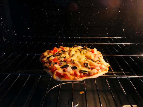 istock Pizza cooking homemade in oven backgrounds 1263416359
