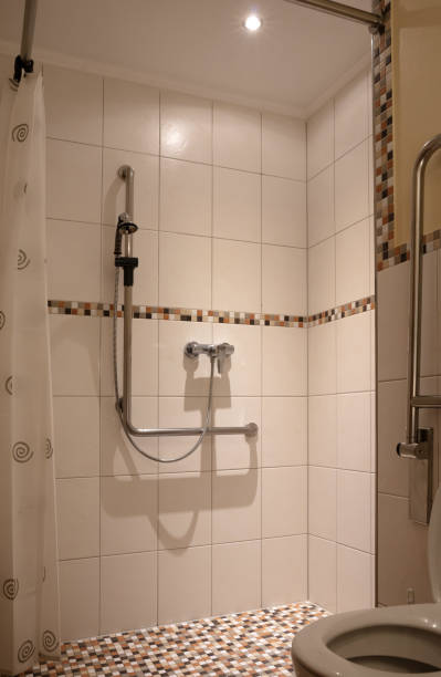 istock Old style bathroom interior with tile floor, adjusted for disabled persons 1263417037