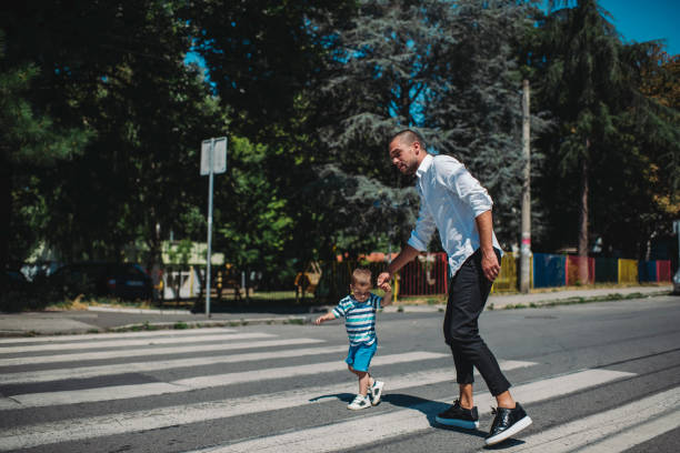 istock Father and son walking on street 1263418369