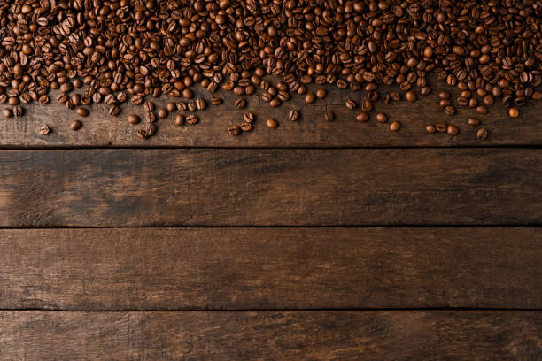 istock Coffee beans on wooden background with copyspace. 1263419739