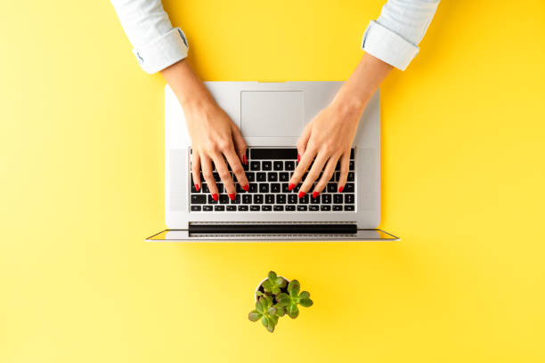 istock Elegant office desktop with female hands working on laptop. Business workspace 1263419775