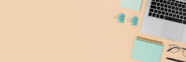 istock Workspace banner with laptop and office supplies on a beige background. 1263419787
