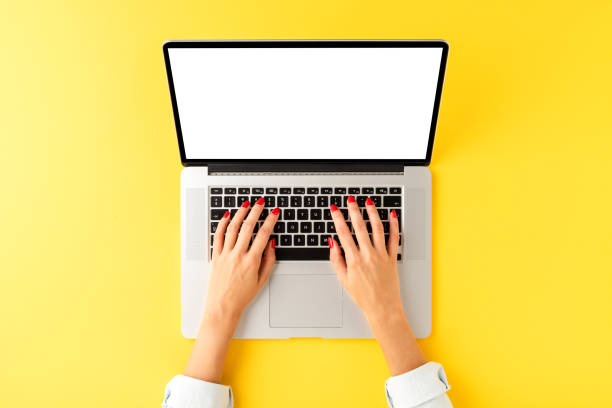 istock Woman’s hand working on laptop with empty screen. Office desktop concept. Top view 1263419892