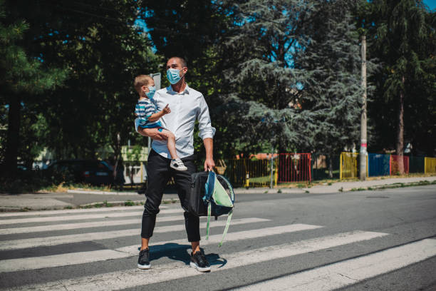 istock Young businessman taking son to preschool. 1263420770