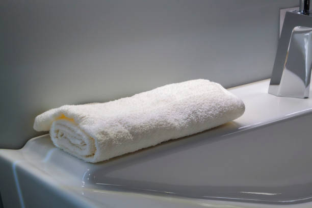 istock white neatly folded towel on sink in the bright bathroom 1263421078