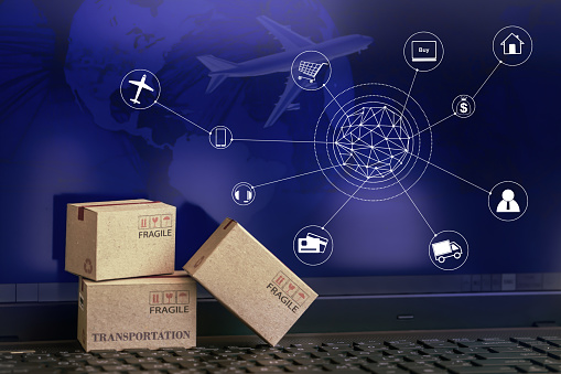 Cardboard boxes packaging the products on computer notebook background. concept about transportation or global shipping or international freight,overseas trade. online shopping concept.