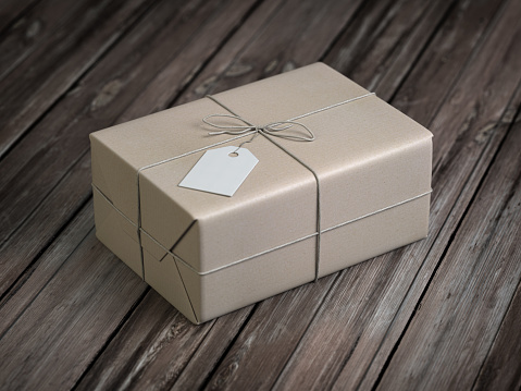 Craft paper gift box with empty label on wooden table. Delivery copncept. 3d illustration