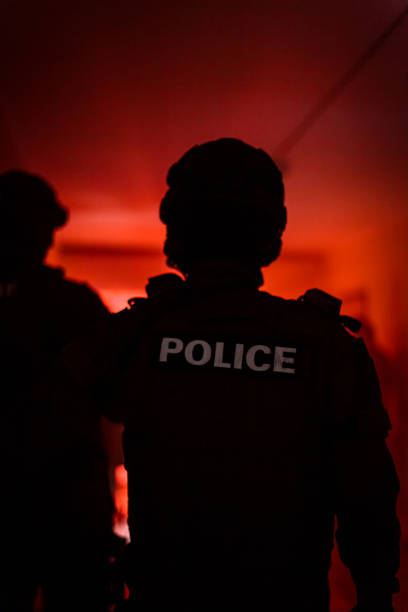 Silhouette of a police officer. Police commando in action, arresting the perpetrator in the building Silhouette of a police officer. Police commando in action, arresting the perpetrator in the building. shutterstock images for free stock pictures, royalty-free photos & images