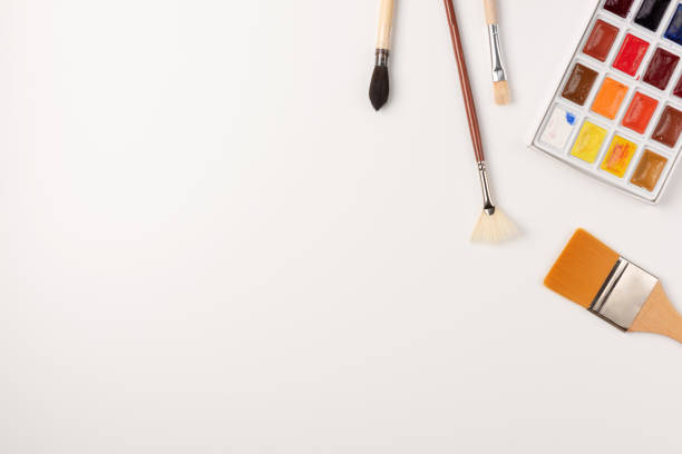istock Watercolor paints, brushes isolated on white background. Copy space. Top view. Flat lay. 1263424794