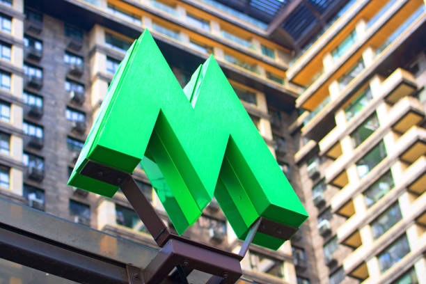KYIV, UKRAINE - JULY 04, 2020: Green metro sign and modern building as background