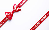 Happy Black Friday Written Red Tied Bow over White Background