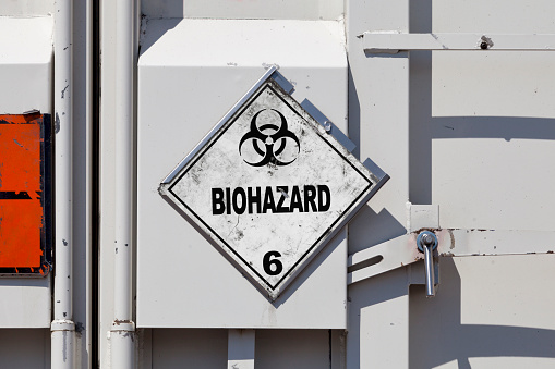 Dangerous goods sign on a truck back door. The white placard indicate that the goods transported are Biohazardous substances.