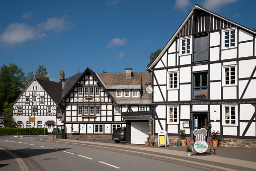 Schmallenberg, Germany - June 12, 2020: Image of old half-timbered houses against blue sky in summertime on June 12, 2020 in Oberkirchen, Schmallenberg, Sauerland, Germany