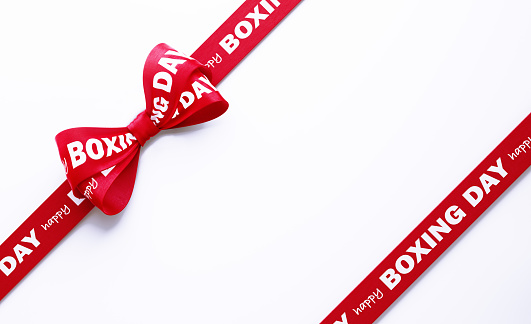 Happy Boxing Day written red tied bow over white background. Horizontal composition with clipping path and copy space. Boxing Day concept.