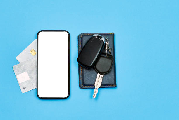 Car keys, mobile phone and credit cards on blue Car keys, mobile phone and credit cards on blue background. Top view. Do not forget to take car keys, money and smartphone before leaving home phone wallet keys stock pictures, royalty-free photos & images