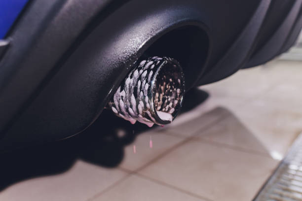 istock Car exhaust pipe with soap. Car wash background. close-up 1263433664