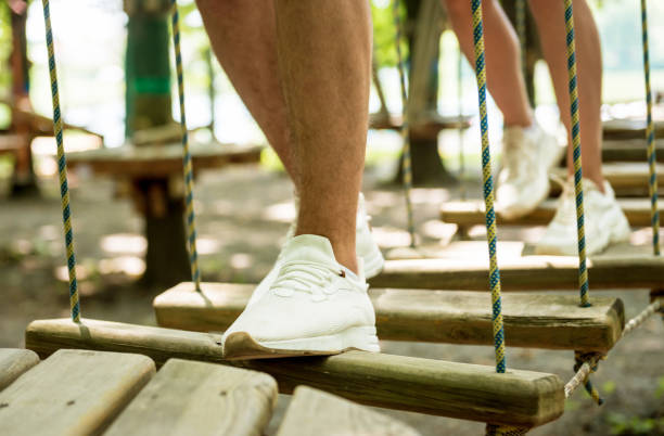 istock Young couple having fun time in adventure rope park. 1263435471