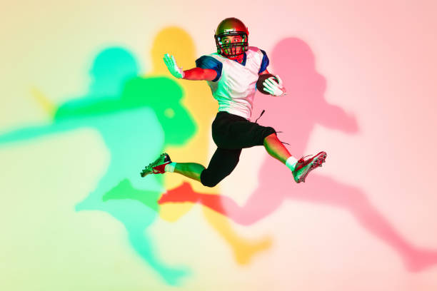 istock American football player isolated on gradient studio background in neon light with shadows 1263436390