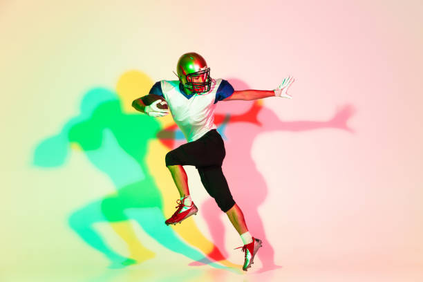 istock American football player isolated on gradient studio background in neon light with shadows 1263436397