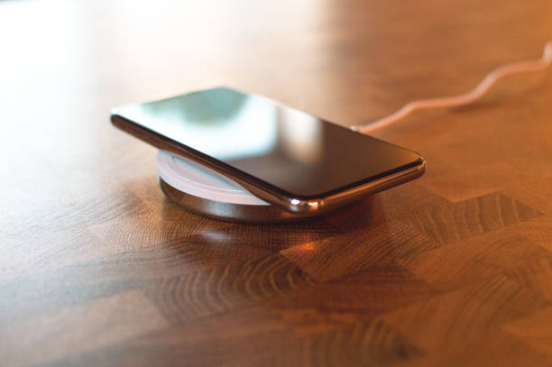 istock Phone charging on a wireless charger close u 1263440186