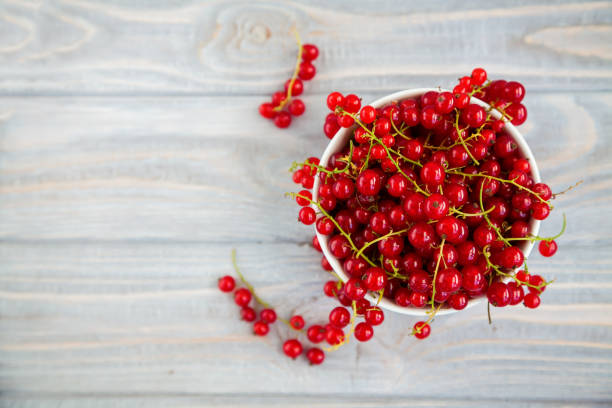 istock Juicy fresh red currant in a white bowl 1263446052