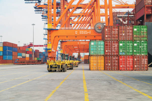 istock Cargo ship being unloaded with containers at port. 1263446117