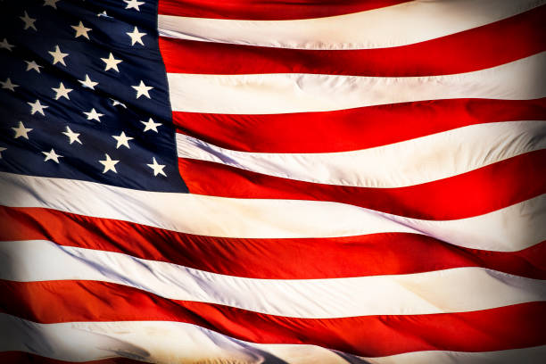 istock Closeup large American flag blowing in wind 1263447642