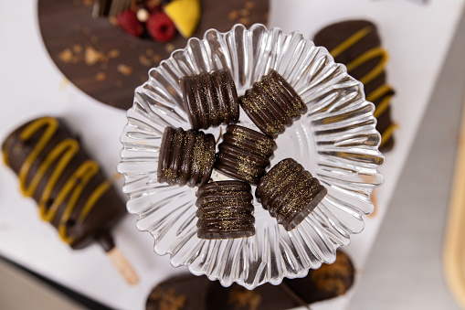 Golden pralines on plate