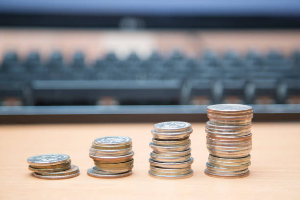 istock Coins on the desktop. The concept of saving working time. 1263449170
