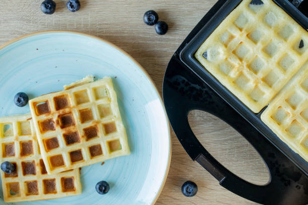 istock Waffles Being Baked in the Waffle Maker. Savory waffles. Breakfast concept 1263452775