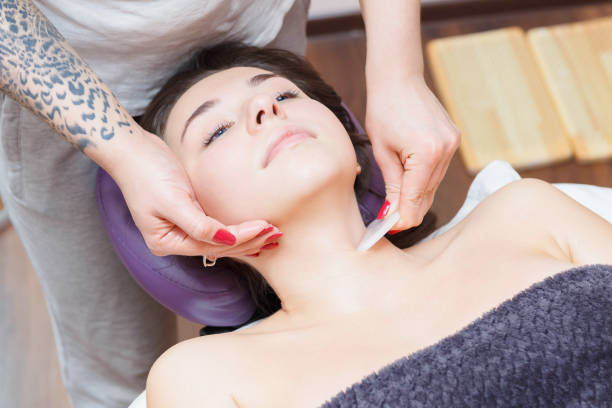 istock The master gives a facial massage to the client. 1263455201