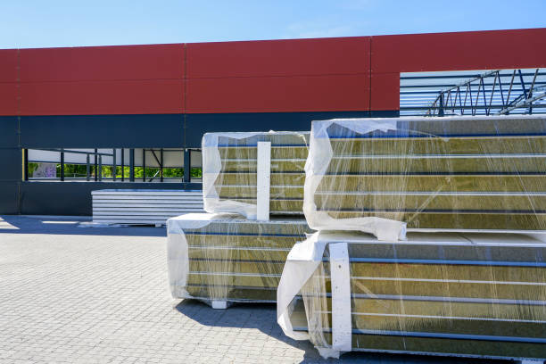 a pile of sandwich facade panels on the construction site of a new metal frame building a pile of sandwich facade panels on the construction site of a new modern metal frame building sandwich panel photos stock pictures, royalty-free photos & images