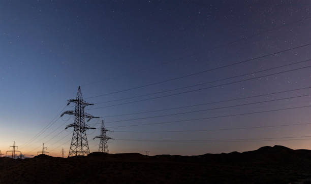 istock Power lines under the starry sky in the desert 1263460680