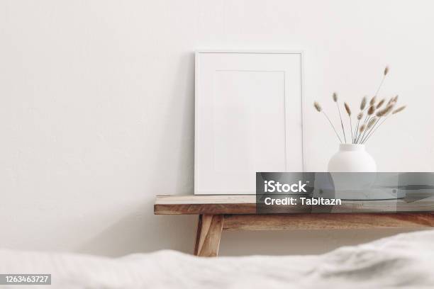 Portrait White Frame Mockup On Vintage Wooden Bench Table Modern White Ceramic Vase With Dry Lagurus Ovatus Grass And Marble Tray Blurred Beige Linen Blanket In Front Scandinavian Interior Stock Photo - Download Image Now